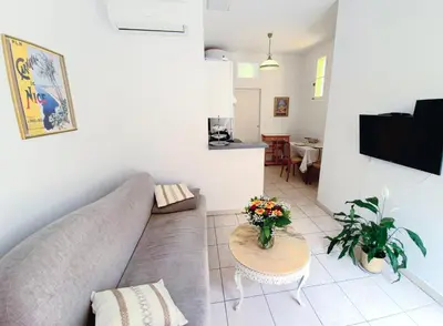 a living room with a couch and a table at L'Appart by la Maïoun Guesthouse in Nice