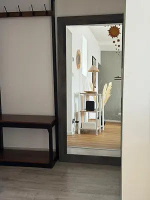 a mirror in a room with a table and a chair at Renovated luxury cocoon Place Masséna in Nice