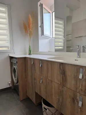 a bathroom with a sink and a washing machine at Renovated luxury cocoon Place Masséna in Nice