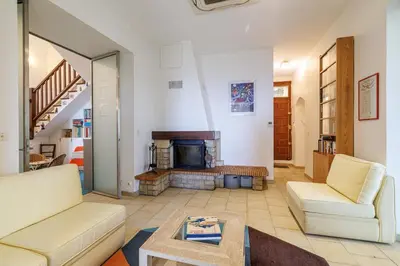a living room with two couches and a fireplace at VILLA MONTE CRISTO - Villa conviviale a Nice - Superbe vue, piscine et jeux en plein air in Nice