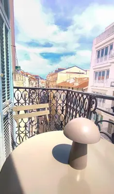 a white stool sitting on a table on a balcony at Ref 119 - Slow Riviera T2 - Rue de France in Nice