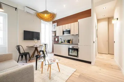 a living room with a couch and a table at 5 BEAUMONT - Magnifique 3P au style boheme - Quartier Garibaldi in Nice