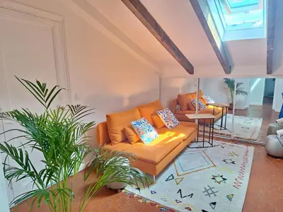 a living room with a couch and a table at Lofty Hideout with 2 bedrooms in Nice