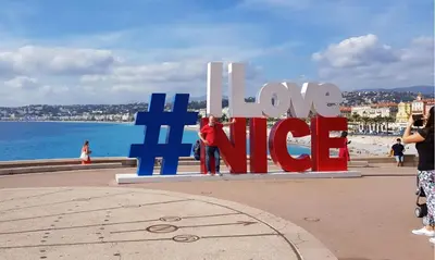 a group of people standing in front of a large sign at Old City Appartement of Nice in Nice
