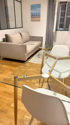 a living room with a couch and a glass table at Old City Appartement of Nice in Nice