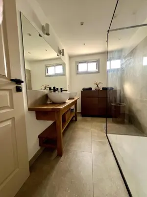 a bathroom with a sink and a glass shower at Lea's cozy nest with a sea-mountain view in Saint-Laurent-du-Var