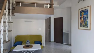 a living room with a couch and a loft bed at Appartement - Nice - Quartier du Port in Nice