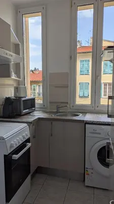 a kitchen with a sink and a washing machine at Appartement - Nice - Quartier du Port in Nice