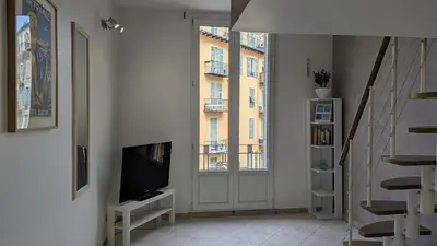 a living room with a tv and a window at Appartement - Nice - Quartier du Port in Nice