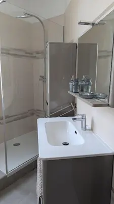 a white bathroom with a sink and a shower at Appartement - Nice - Quartier du Port in Nice