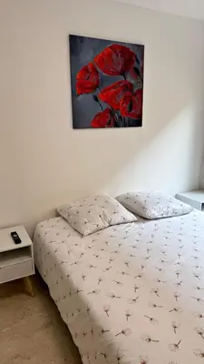 a bedroom with a bed with a painting on the wall at Studio 4 Carré d'Or in Nice