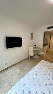 a bedroom with a bed and a tv on a wall at Studio 4 Carré d'Or in Nice
