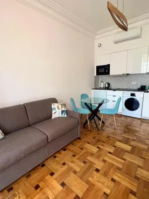 a living room with a couch and a table at Appartement Rex in Nice