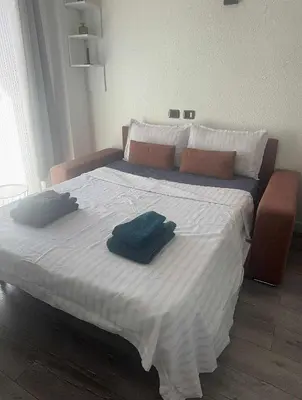 a bedroom with a bed with two towels on it at joli studio en face de la gare in Nice
