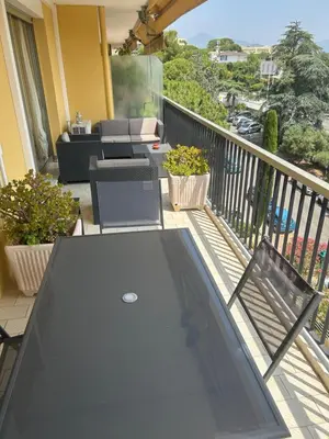 a glass table on a balcony with a view of a patio at Elegant apartment a Nice, Sea View in Nice