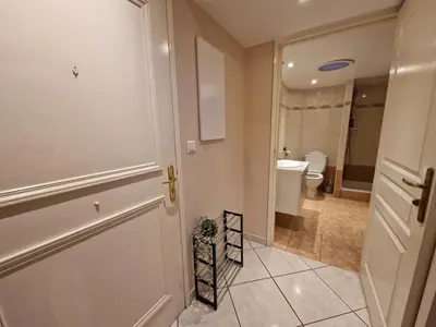 a bathroom with a white door and a toilet at Le Centrale - Place Masséna in Nice