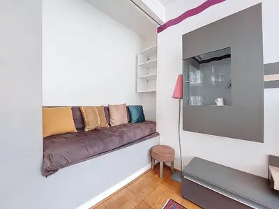 a living room with a couch on a wall at Apartment Daphné by Interhome in Nice