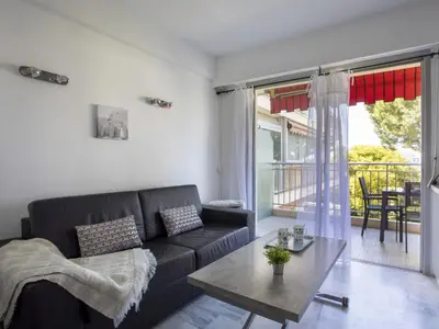 a living room with a couch and a table at Apartment Le Persépolis by Interhome in Cagnes-sur-Mer