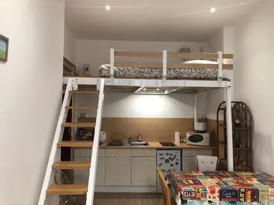 a bunk bed in a room with a kitchen at Agréable studio cœur de Nice in Nice