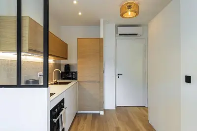 a kitchen with white counters and a white door at Magnifique studio boulevard Gambetta - B in Nice