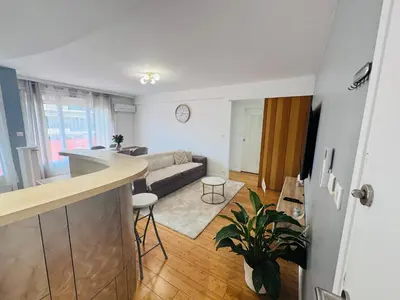 a kitchen and living room with a couch and a table at LE CARRAS - Proche de aéroport , Plage à pied - Promenade des anglais in Nice