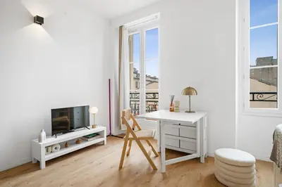 a white living room with a desk and a tv at Soleil Sucré - Splendid cocoon near Jean Médecin in Nice