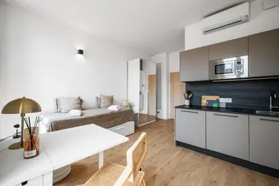 a kitchen and living room with a bed and a table at Soleil Sucré - Splendid cocoon near Jean Médecin in Nice