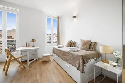a white bedroom with a bed and a desk and windows at Soleil Sucré - Splendid cocoon near Jean Médecin in Nice