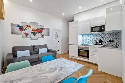 a kitchen and living room with a table and a couch at Nice Renting - VERDUN - Designer Cocoon Massena Calm Air Conditioning in Nice
