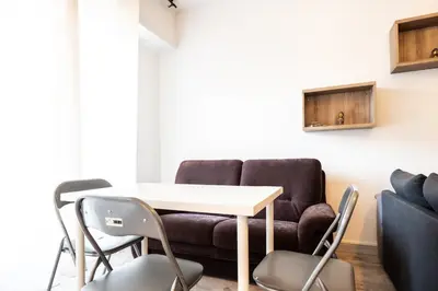 a living room with a table and a couch at La Vague Douce in Nice