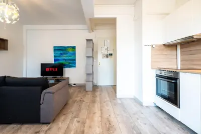 a living room with wooden floors and a couch at La Vague Douce in Nice