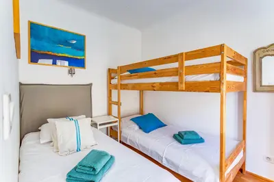 two bunk beds in a room with white walls at EDEN VIEW AP4469 by Riviera Holiday Homes in Villefranche-sur-Mer