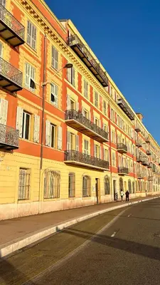 a yellow and orange building on the side of a street at Appartement LOFT in Nice