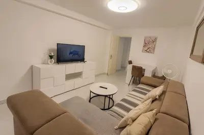 a living room with a couch and a tv at Bahri House in Nice