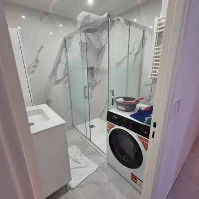 a washing machine in a kitchen with a shower at Bahri House in Nice