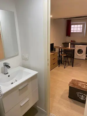 a white bathroom with a sink and a kitchen at Studio Vieux Nice in Nice
