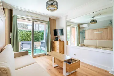 a living room with a couch and a table at Studio Jardin Parking et Clim in Nice