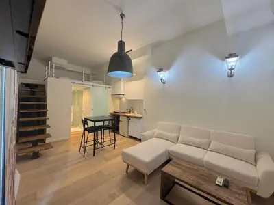 a living room with a couch and a table at ⁂ Charmant Mezzanine Central - Clim Wifi Famille in Nice