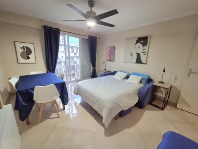 a bedroom with a bed and a ceiling fan at Renoir SeaSide Apartment in Nice