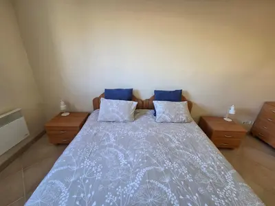 a blue couch in a living room with a ceiling fan at Renoir SeaSide Apartment in Nice