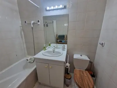 a bathroom with a sink and a toilet and a tub at Renoir SeaSide Apartment in Nice