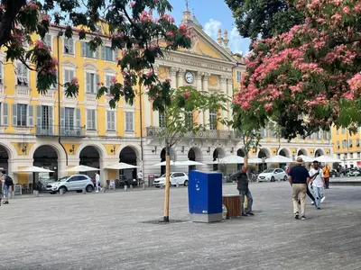 a large yellow building with a clock on it at Recently renovated apartment in quiet area in heart of Old Nice in Nice