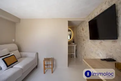 a living room with a couch and a flat screen tv at Studio in Villefranche in Villefranche-sur-Mer