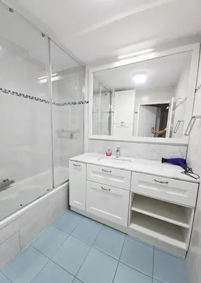 a white bathroom with a sink and a shower at Nice Riquier 8 in Nice