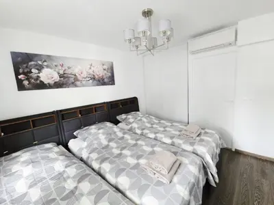 two beds in a room with white walls at Nice Riquier 8 in Nice