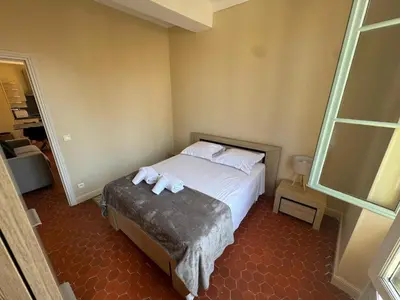 a bedroom with a bed with two towels on it at STE REPARATE - Cosy 2 pieces vue cathedrale in Nice