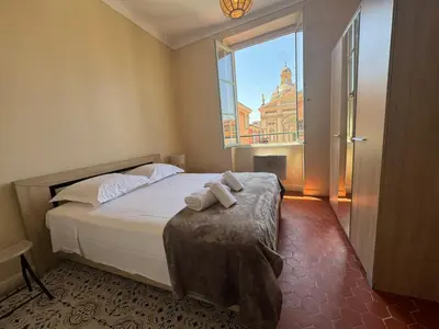 a bedroom with a bed and a large window at STE REPARATE - Cosy 2 pieces vue cathedrale in Nice