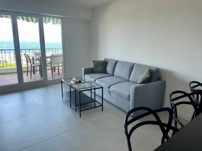 a living room with a couch and a table at Azure blue in Nice