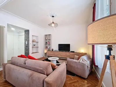 a living room with a couch and a tv at Nestor&Jeeves - NISSA - Central location in Nice