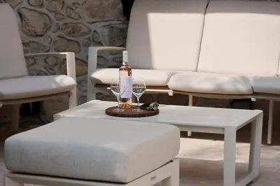 a bottle of wine sitting on a table next to a couch at Central Luxurious Property in Antibes